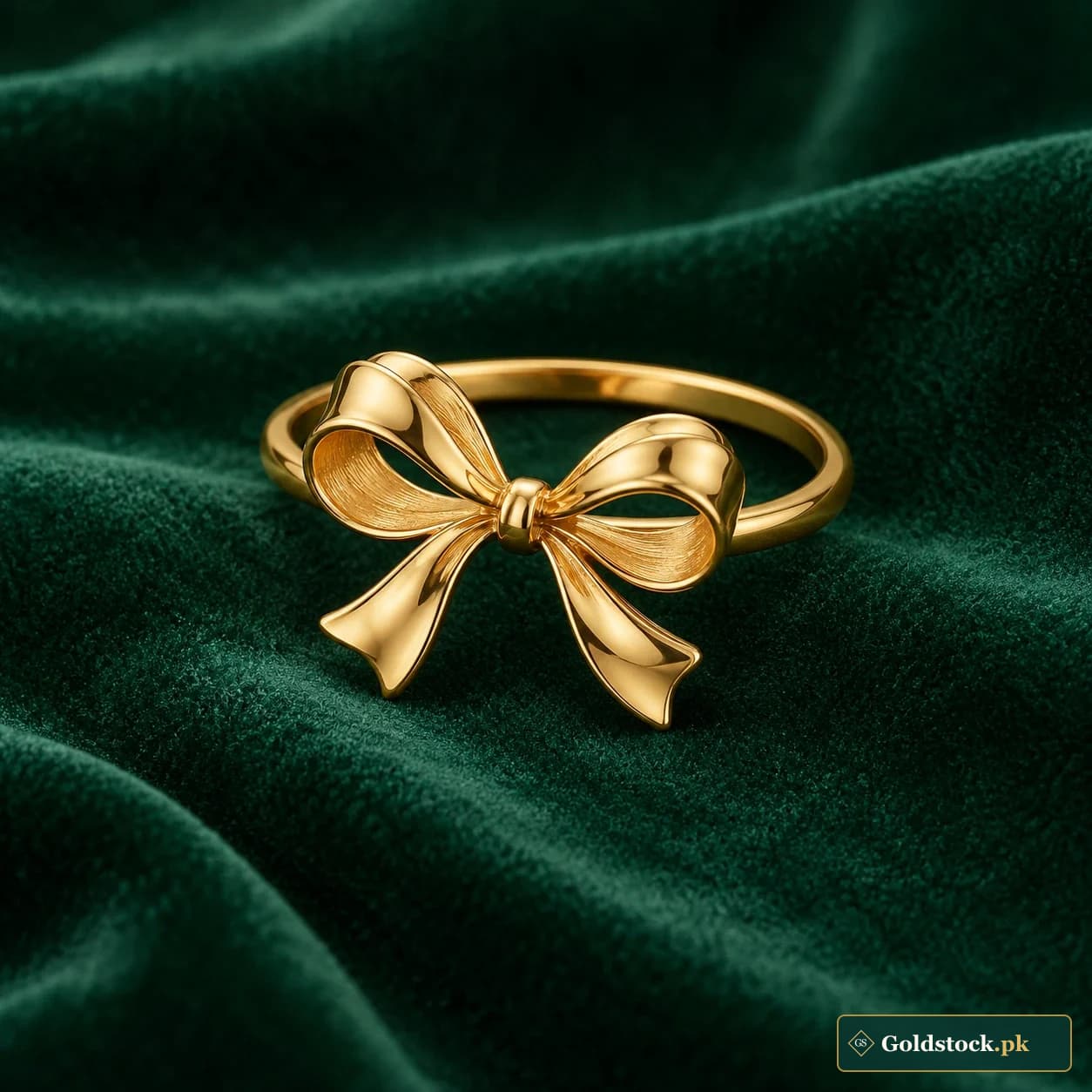Abeer Bow Ring: a gold-tone ring with a sculptural ribbon-bow face and a smooth narrow band