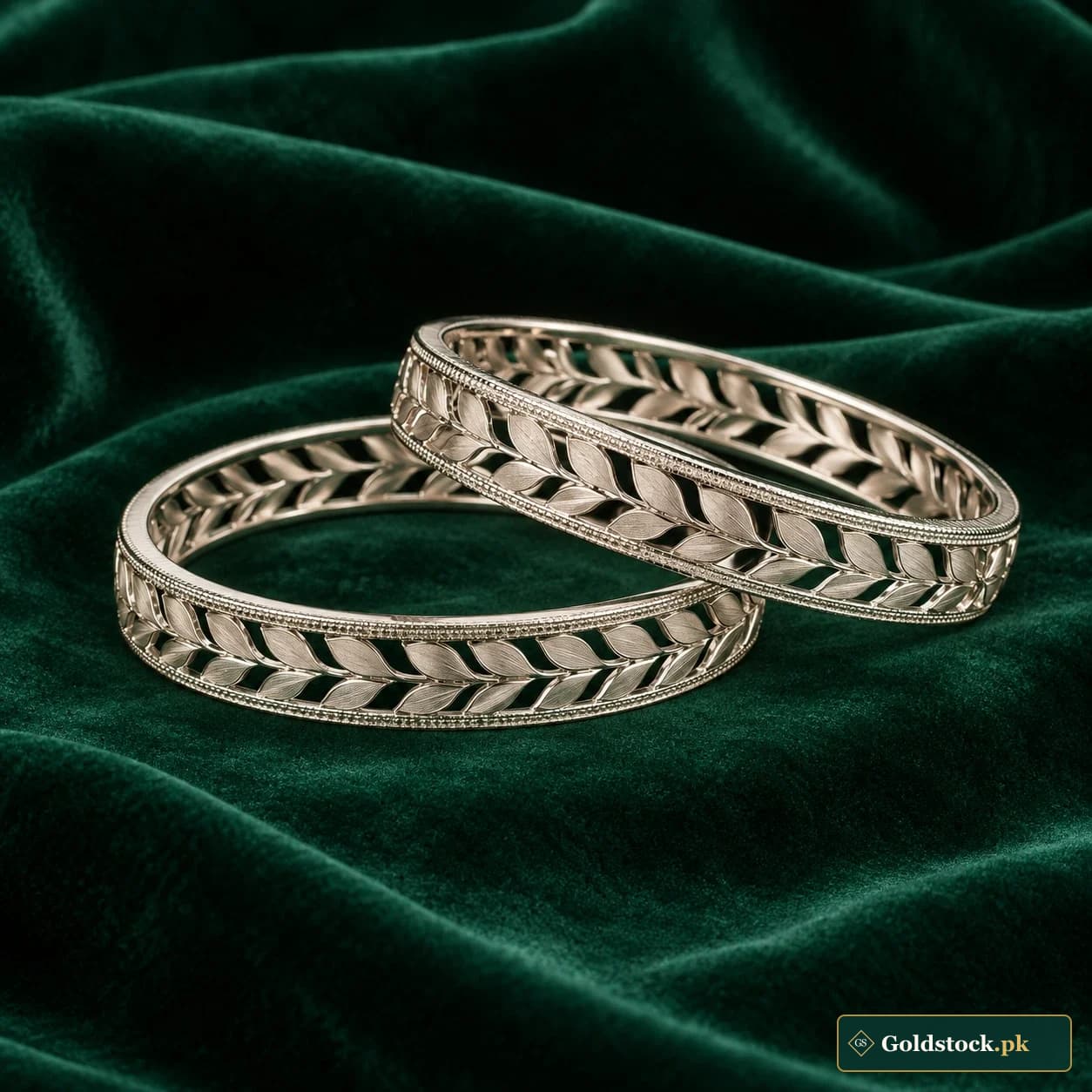 Mishal Leaf-Cut Bangles: a pair of silver-tone bangles with repeated leaf-shaped cutouts