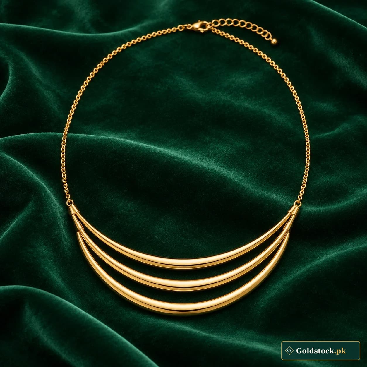 Zunaira Arc Necklace: a gold-tone necklace with three graduated smooth curved bars at the front