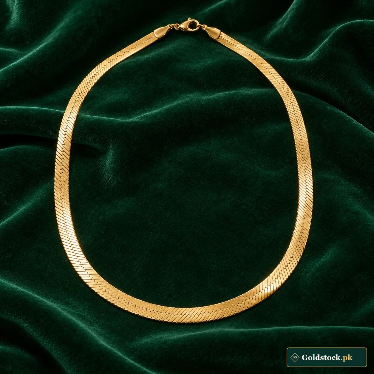 Nayab Herringbone Chain: an unadorned gold-tone neck chain with a flat herringbone-patterned surface