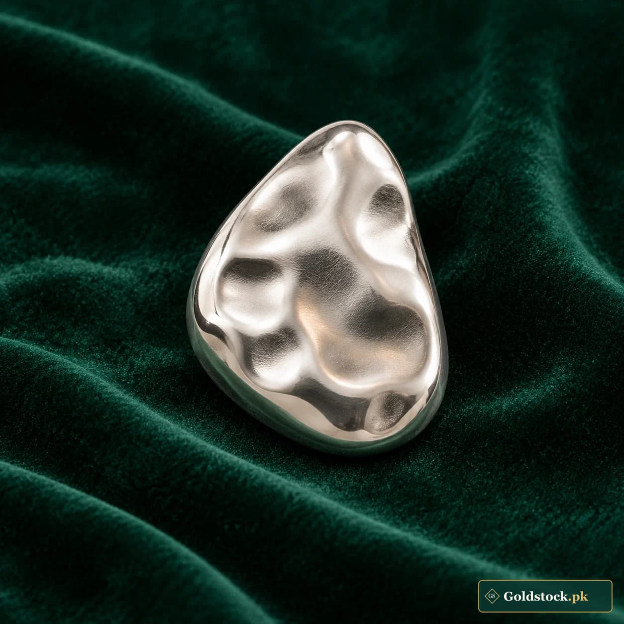 Pebble Silver Bullion Form: an asymmetric pebble-shaped silver-tone bullion form with a softly dimpled surface