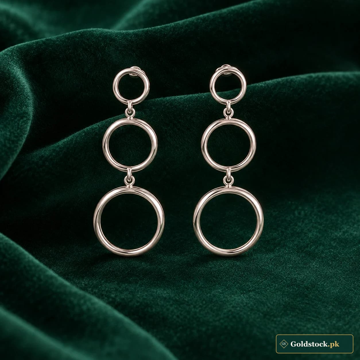 Maha Orbital Drop Earrings: a pair of silver-tone earrings with three graduated open circles suspended vertically