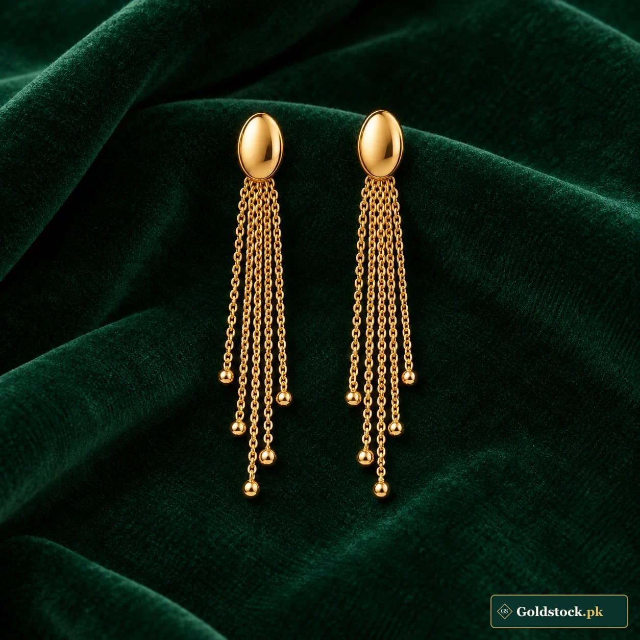 Lina Chain Tassel Earrings: a pair of gold-tone earrings with small oval studs and several slender chain tassels