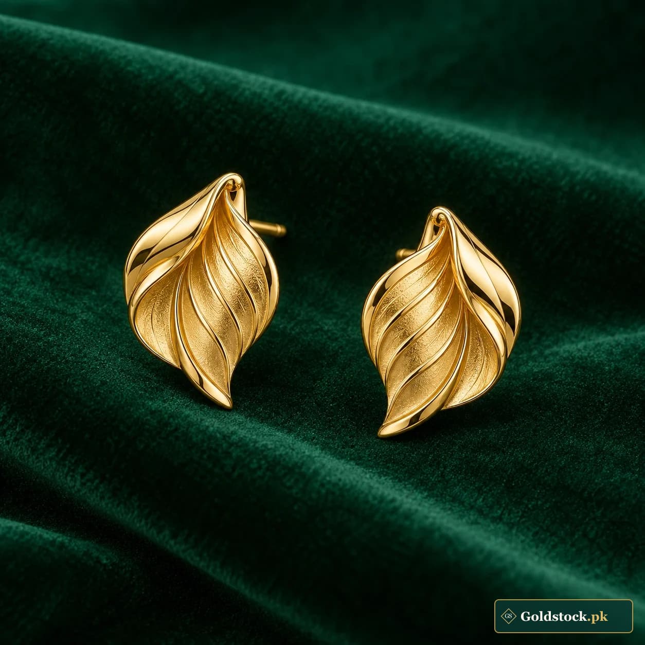 Alizeh Leaf Stud Earrings: a pair of gold-tone stud earrings shaped as folded polished leaves