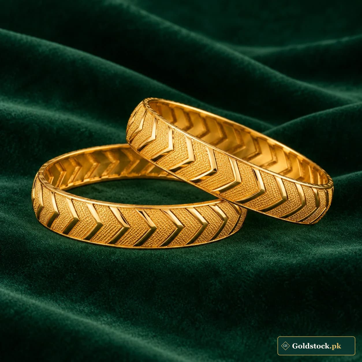 Rameen Chevron Bangles: a pair of gold-tone bangles with repeated raised chevron patterns